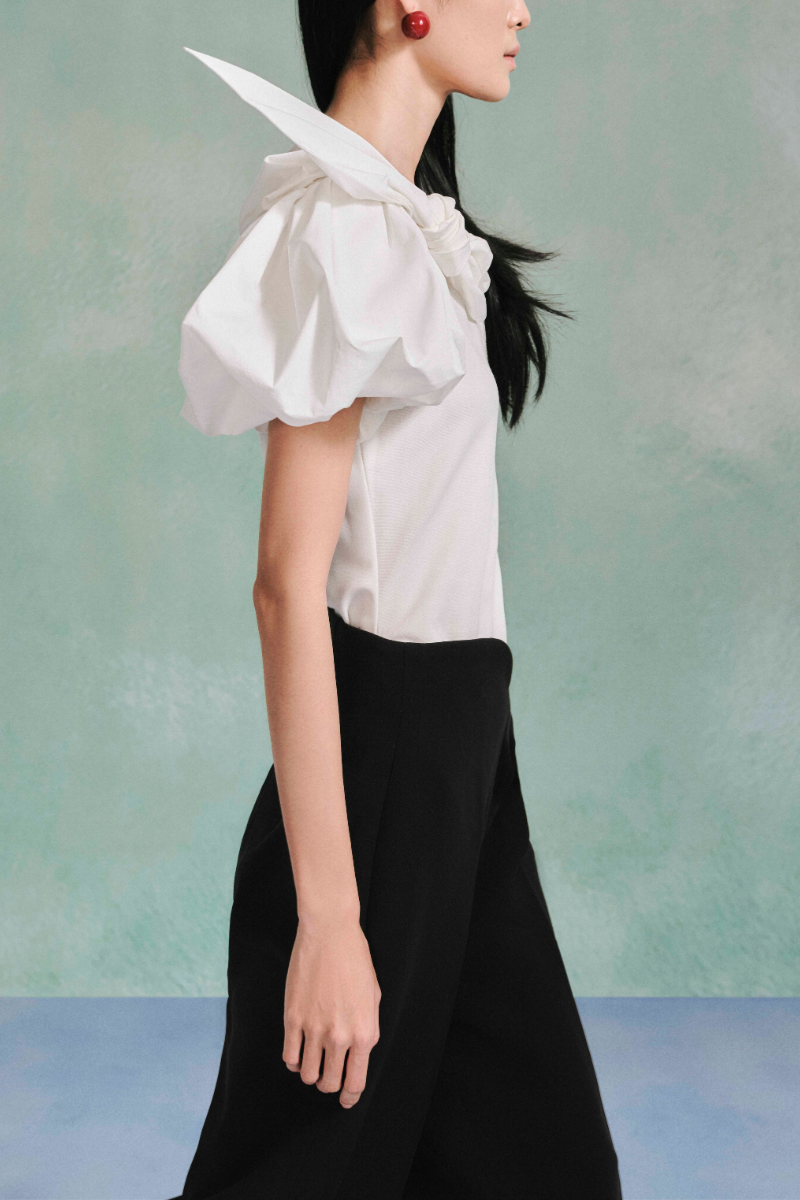 Light blue puff sleeve cotton top by LECIA featuring a relaxed fit and ruffled details on the sleeves.