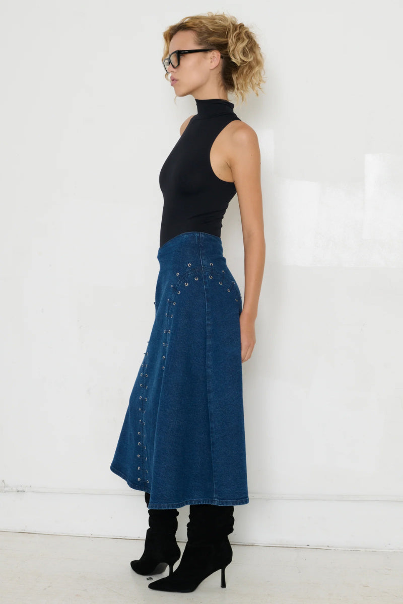 TT Studios midi skirt featuring a stylish, flowy design with a high waist and elegant length, perfect for casual or dressy occasions.