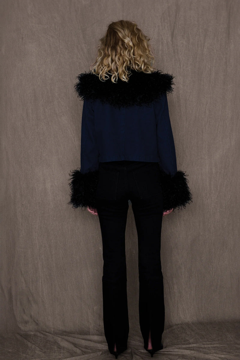 Black KIMMY Jacket by TT Studios featuring a sleek design and zip-up closure, displayed on a hanger.