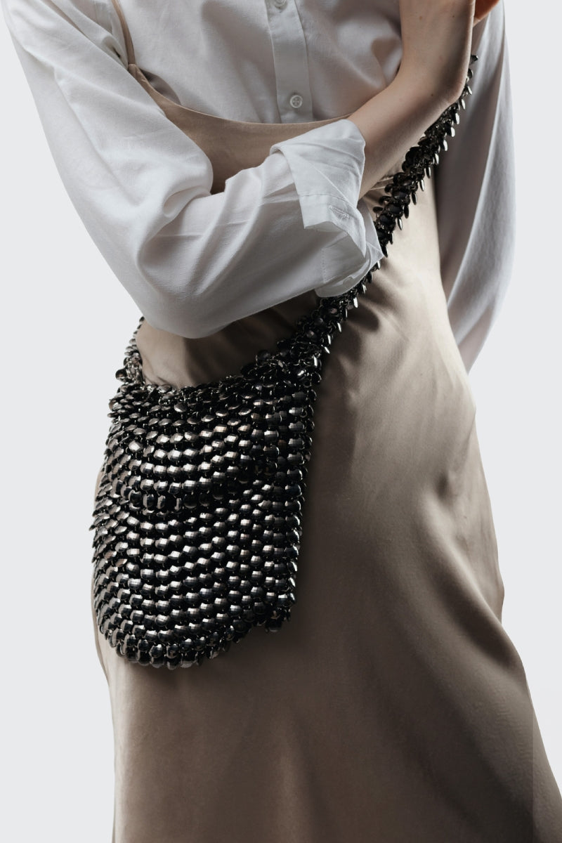 Millanne Tale RHONIEE shoulder bag with sleek design, showing adjustable strap and spacious interior in a stylish fashion.