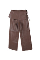 Brown leather pants by Double A featuring a stylish fit, shown on a model with detailed stitching and a sleek design.