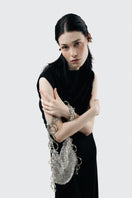 Elegant glass shoulder bag by Millanne Tale featuring transparent design and stylish shoulder strap for modern fashion.