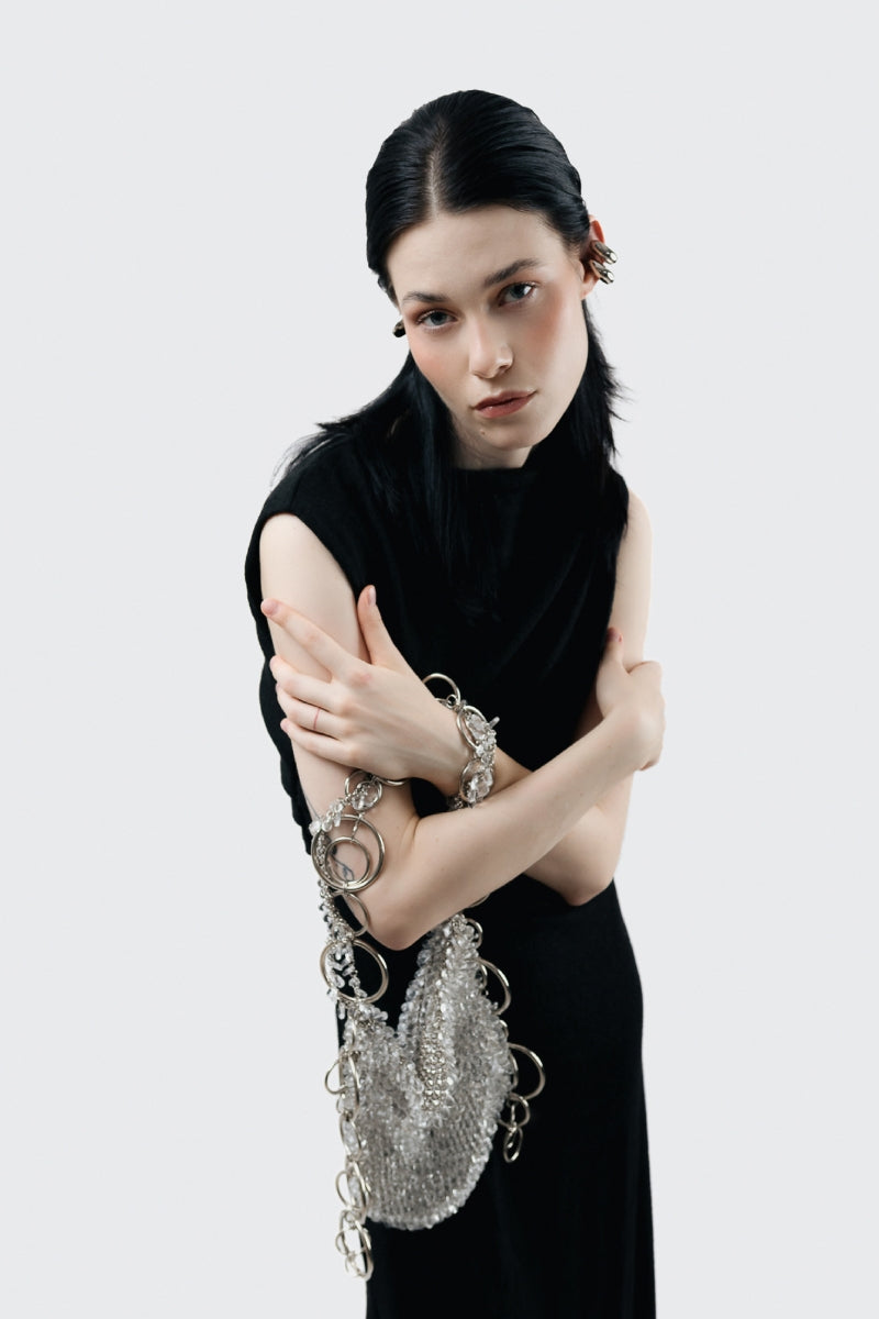 Elegant glass shoulder bag by Millanne Tale featuring transparent design and stylish shoulder strap for modern fashion.