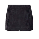 Black LEKIEU Amiens mini skirt displayed on a hanger, showcasing its sleek design and fitted silhouette.