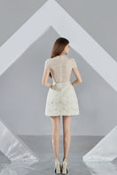 Beige MELINA A-line organza mini dress by HAPPY CLOTHING, shown on a model with flowy fabric and elegant design.