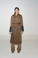 Ura ADA camel coat displayed on a hanger, stylish long coat made of warm fabric, featuring a classic design and tailored fit.