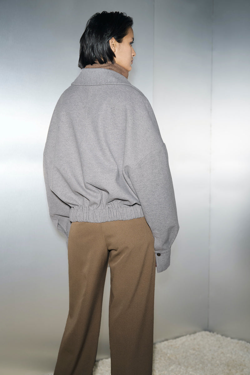 Gray Steph jacket by URA, showcasing a stylish, lightweight jacket with a zip-up front and modern design details.