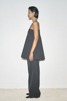 Gray URA Ruth trousers, stylish pants with a tailored fit, shown on a model in a casual setting.