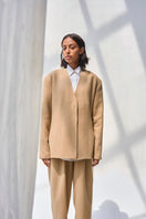 Cream Leah blazer by URA featuring tailored fit, notched lapels, and stylish design, perfect for professional or casual wear.