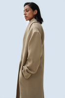 Ura ISA coat in neutral fabric with a classic tailored fit, featuring a collar and button closure, displayed on a hanger.