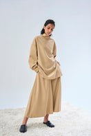 Elegant EIRA top by URA featuring a stylish design, displayed on a mannequin with a focus on fabric and fit.