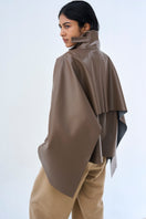 Ura PIA trench jacket in neutral color, tailored fit with classic design, displayed on a hanger.