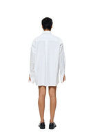 Blue DIMA shirt by URA with a button-up front and collar, displayed on a hanger against a neutral background.
