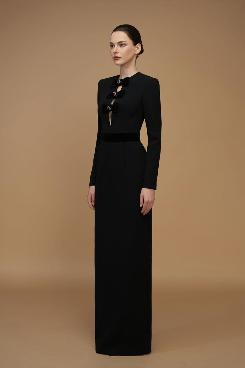 Black crepe de chine and velvet gown by I.H.F featuring a V-cut neckline and long sleeves, elegant evening wear.