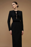 Elegant black crepe de chine and velvet gown by I.H.F featuring a V-cut neckline and long sleeves, displayed on a dress form.