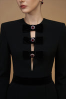 Elegant black crepe de chine and velvet gown by I.H.F featuring a V-cut neckline and long sleeves.