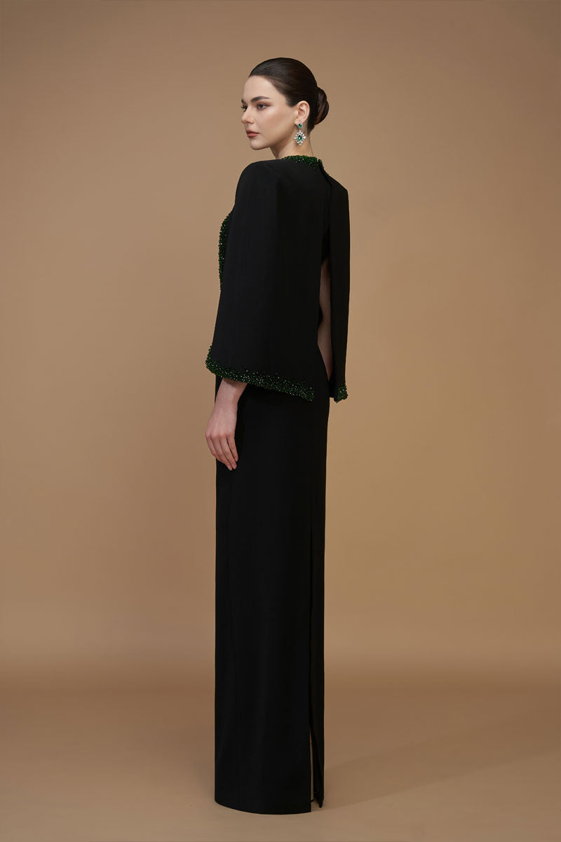 Elegant black emerald gown by I.H.F featuring a V-neck, crepe and silk lining, and stylish cape sleeves.