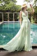 Elegant DOROTHEA MINT SILK PLEATED MAXI DRESS by 21Six, featuring a flowing silhouette and intricate pleats in a soft mint green fabric.