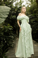 Elegant mint silk ruffle maxi dress by 21Six, featuring flowing fabric and stylish ruffle details.