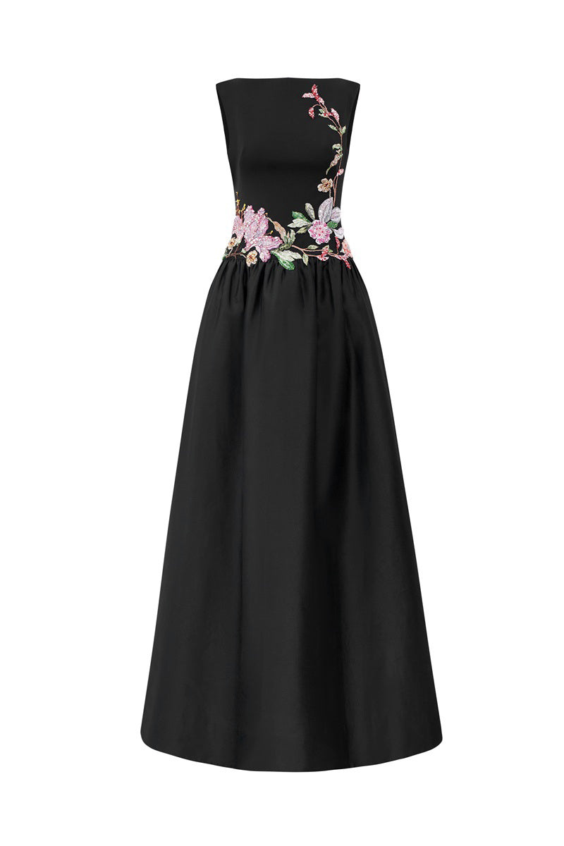 Black crepe maxi dress by Tracy Studio with embellishments, featuring a flowing silhouette and elegant design.