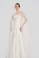 Elegant taffeta gown with cape by Tracy Studio, featuring a flowing silhouette and sophisticated design.