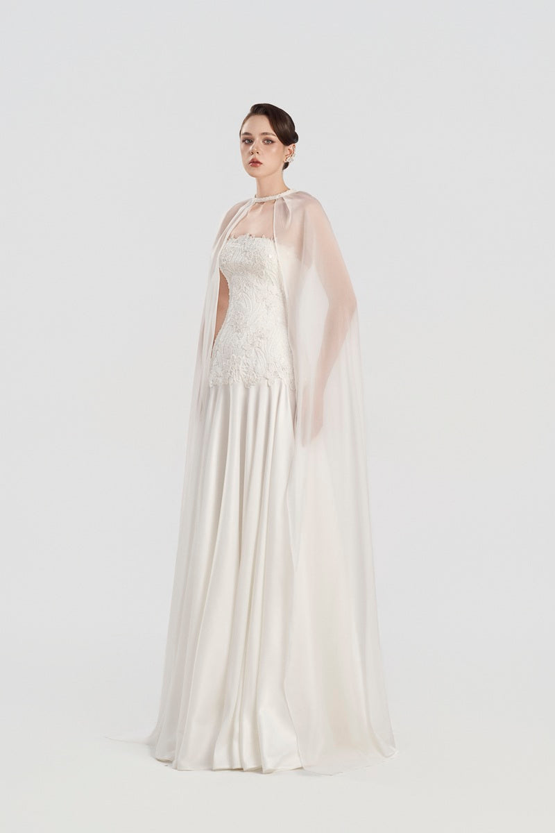 Elegant Tracy Studio taffeta maxi dress with attached cape, flowing silhouette, and intricate fabric details.