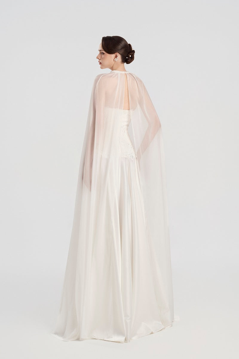 Elegant Tracy Studio taffeta maxi dress with an attached cape, featuring a flowing silhouette and sophisticated design.