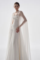 Elegant taffeta dress with cape by Tracy Studio, showcasing a flowing gown with sophisticated design and intricate fabric details.