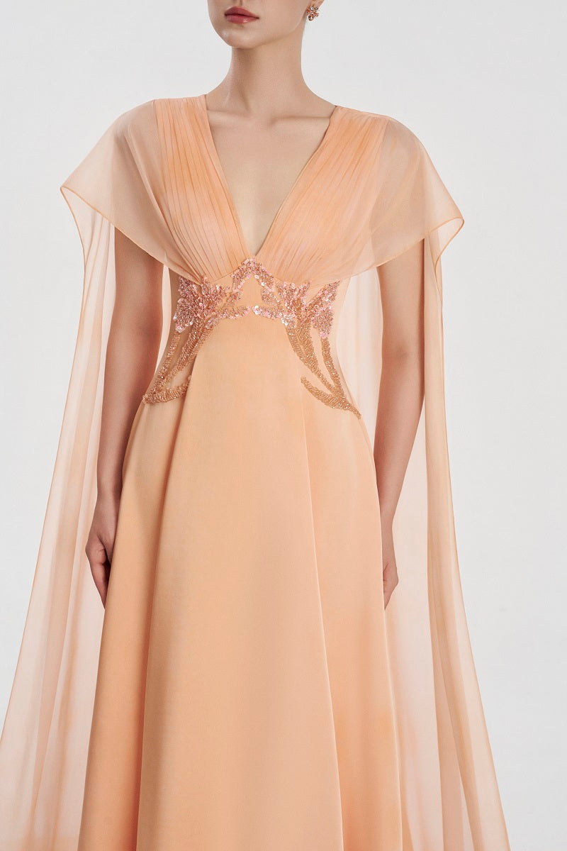 Elegant Tracy Studio satin deep V-neck maxi dress displayed on a hanger, showcasing its smooth fabric and flowing silhouette.
