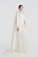 Elegant satin jumpsuit by Tracy Studio featuring 3D floral embellishments and a sleek, modern design.