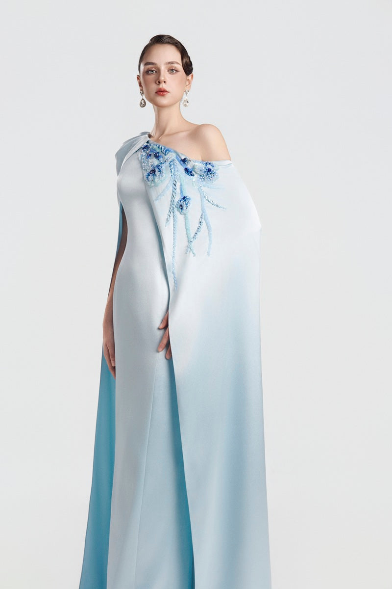 Blue asymmetrical taffeta maxi dress by Tracy Studio, flowing fabric with elegant design, shown on a model.
