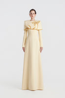 Yellow viscose matte gown by Tracy Studio, flowing design with long sleeves and elegant drape, perfect for formal occasions.