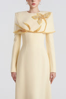 Yellow viscose matte gown by Tracy Studio, flowing design with long sleeves and elegant silhouette.