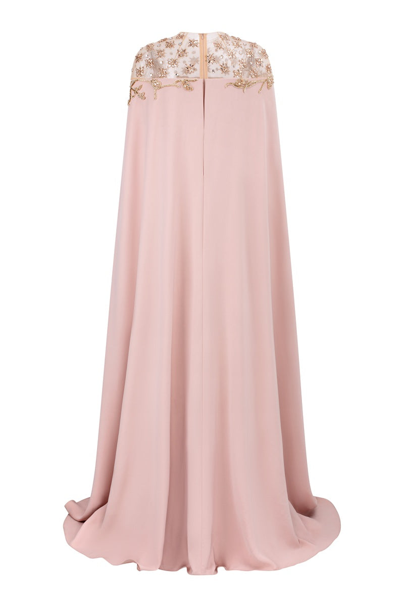 Apricot velvet satin maxi dress by Tracy Studio, featuring a flowing silhouette and elegant drape, displayed on a hanger.