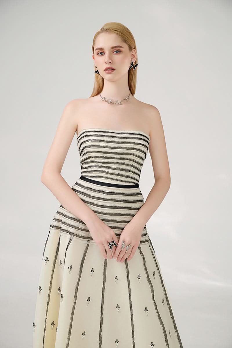 Elegant strapless black and beige A-line gown by Happy Clothing, featuring a flowing silhouette and sophisticated design.
