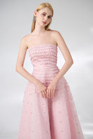 Pink strapless stone organza midi dress by Happy Clothing, showcasing elegant fabric and a fitted bodice on a model.