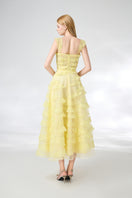 Light yellow organza layered gown by Happy Clothing, featuring flowing fabric and elegant design, perfect for formal occasions.