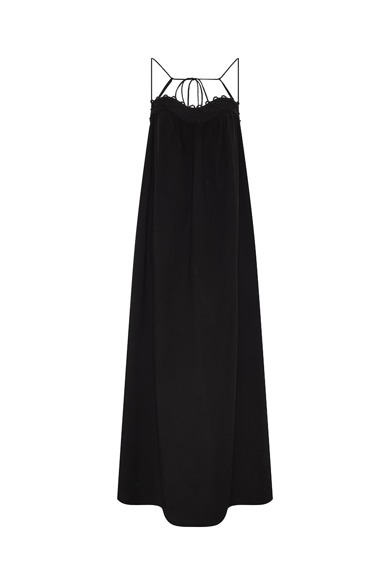 DUMA&CO Resonancia Maxi Dress in vibrant patterned fabric, flowing design with long sleeves and a fitted waist.