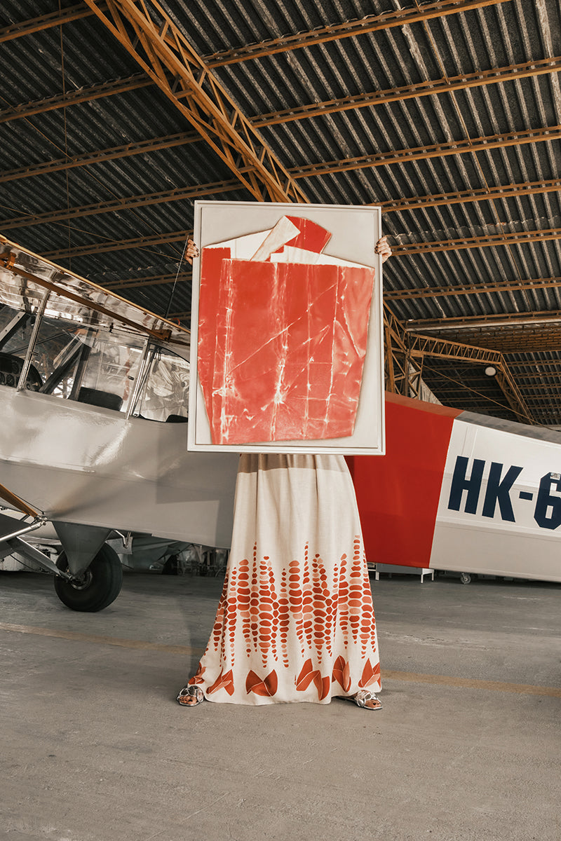 DUMA&CO LINDE maxi dress with floral pattern, flowing fabric, and sleeveless design displayed on a hanger.