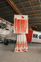 DUMA&CO LINDE maxi dress with floral pattern, flowing fabric, and sleeveless design displayed on a hanger.