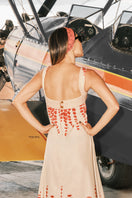 DUMA&CO LINDE maxi dress in vibrant floral print with flowing fabric and sleeveless design, displayed on a hanger.
