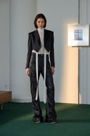 Black Lorena Saravia VERA jacket in crepe fabric, stylish and tailored, displayed on a hanger against a neutral background.