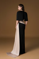 Black and ivory crepe silk-lined gown with v-neck and asymmetric draped detail, featuring a mini cape from I.H.F.