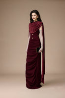 Jenny K Tran burgundy volley dress gown displayed on a hanger with intricate lace details and elegant flowing fabric.