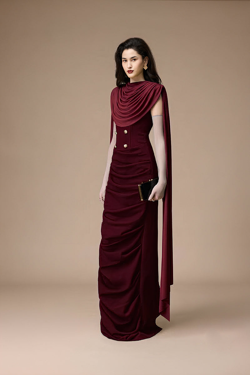 Jenny K Tran burgundy volley dress gown displayed on a hanger with intricate lace details and elegant flowing fabric.