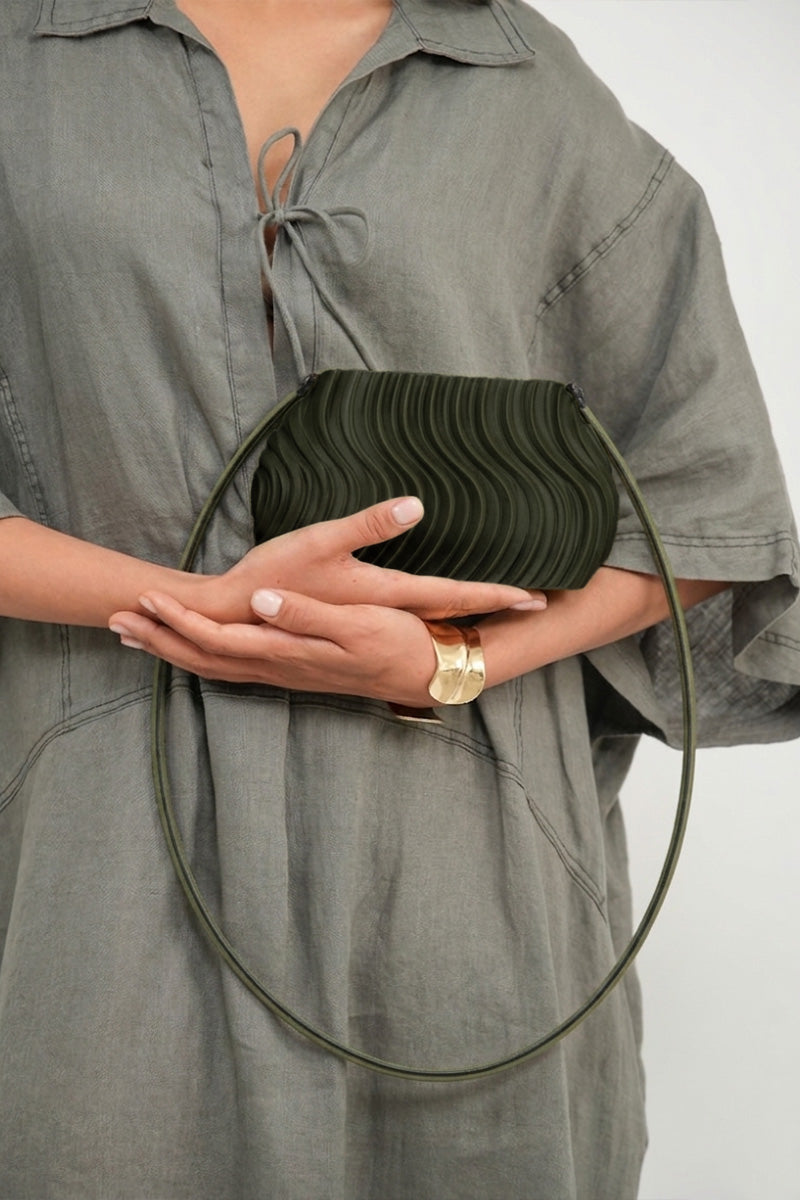 Touchless olive long shoulder bag with adjustable strap, stylish design, and spacious interior for everyday use.