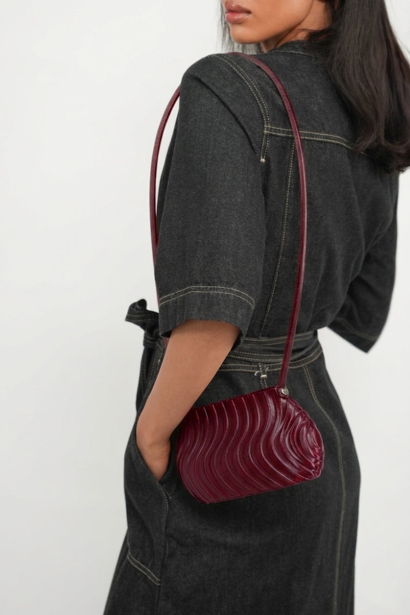 Touchless plum long shoulder bag with adjustable strap and spacious interior, stylish for everyday use.