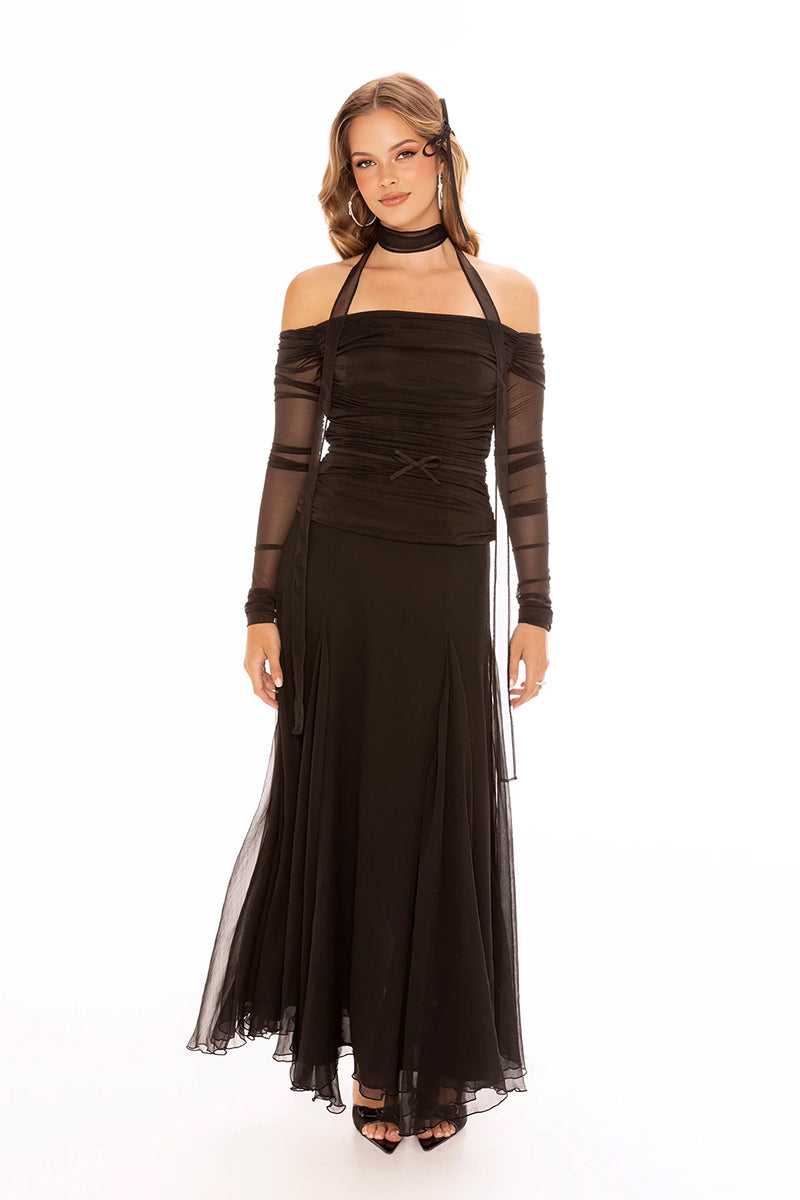 Nana Jacqueline Valencia black maxi skirt displayed on a model, flowing fabric and elegant design for sophisticated style.