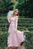 Pink Valencia maxi skirt by Nana Jacqueline, flowing fabric, high waist, and elegant design in a fashion campaign setting.