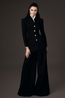 Valenciani high collar fitted blazer and wide-leg trousers co-ord set, shown on a model in a stylish indoor setting.